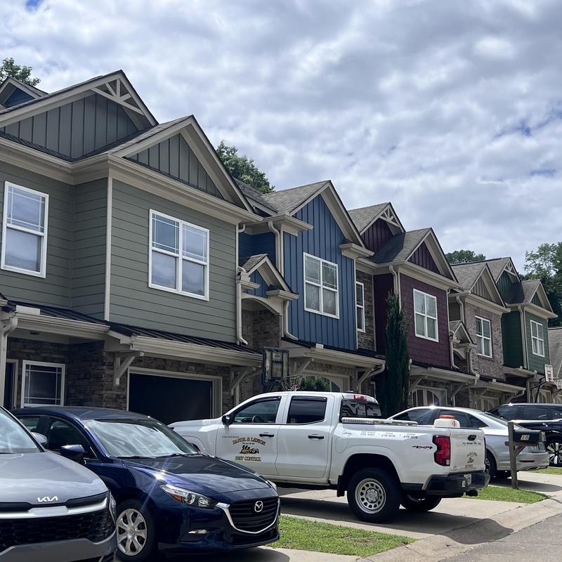 Townhome gutters with vehicles parked outside