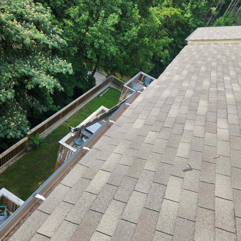 Roof gutter dislodged and bent on townhome roof edge