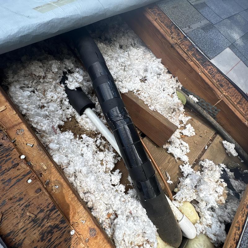 Refrigerant line with black insulation and tape in attic Refrigerant line with black insulation and tape in attic
