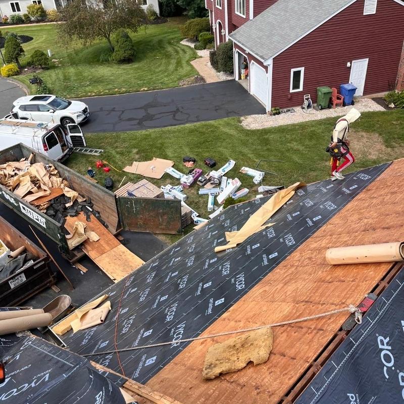 Roof underlayment installation on residential roof in progress