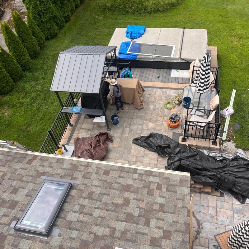 Skylight and shingle roof installation in progress