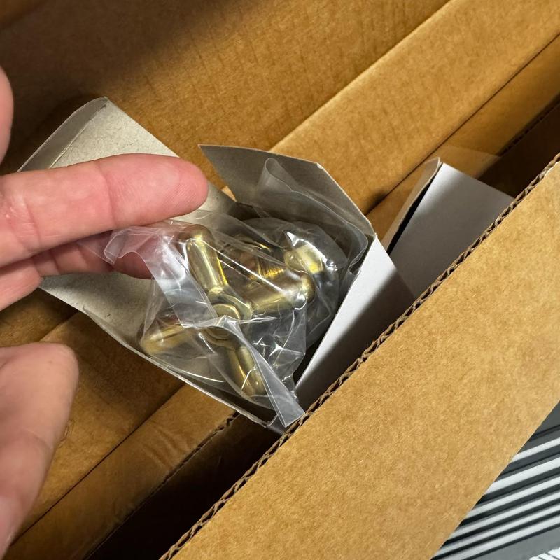 Toilet tank hardware bolts in plastic packaging