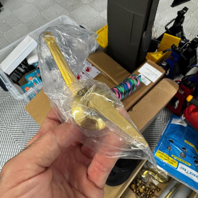 Toilet handle lever wrapped in plastic packaging