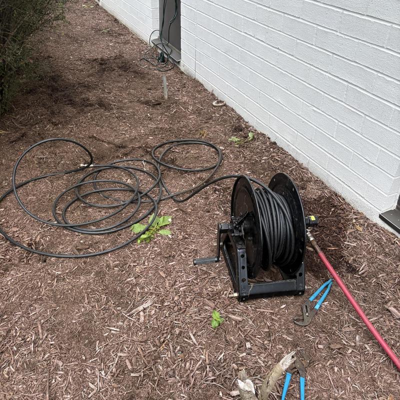 Sewer drain snake and clog removal tools outside building Sewer drain snake and clog removal tools outside building