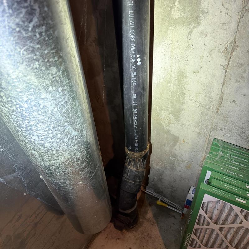 Main stack waste line pipe with ductwork nearby