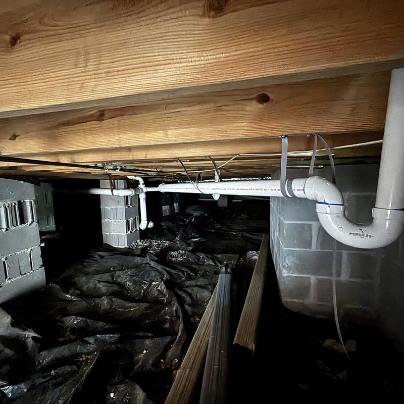 PVC drain pipes installed in crawl space with supports PVC drain pipes installed in crawl space with supports