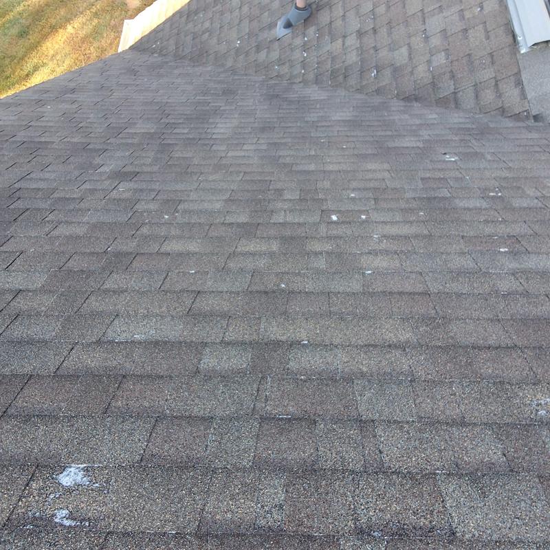 Asphalt shingle roof with visible wear near dormers Asphalt shingle roof with visible wear near dormers