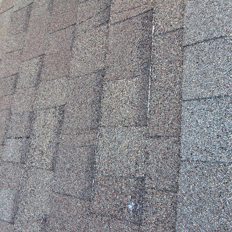 Roof shingles with visible wear and potential damage Roof shingles with visible wear and potential damage