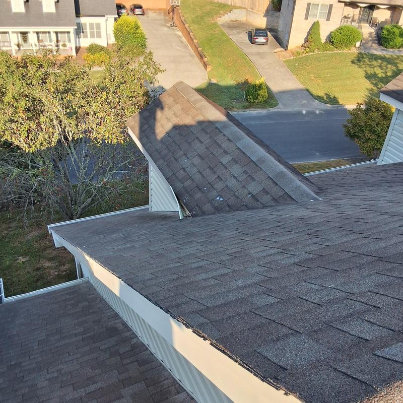 Dormer roof with damaged shingles and edges Dormer roof with damaged shingles and edges