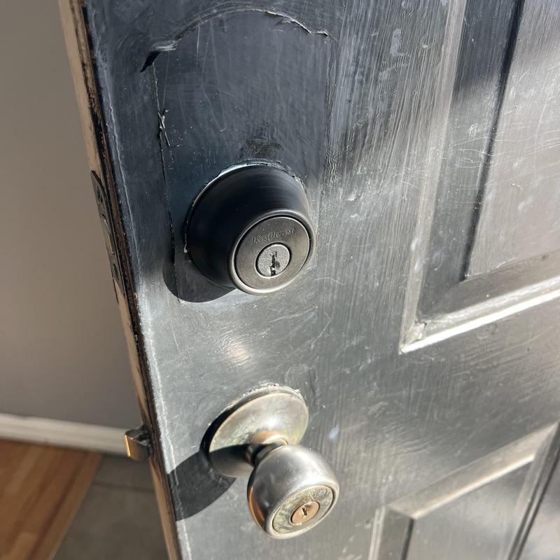 Door deadbolt lock and knob lock on black door Door deadbolt lock and knob lock on black door