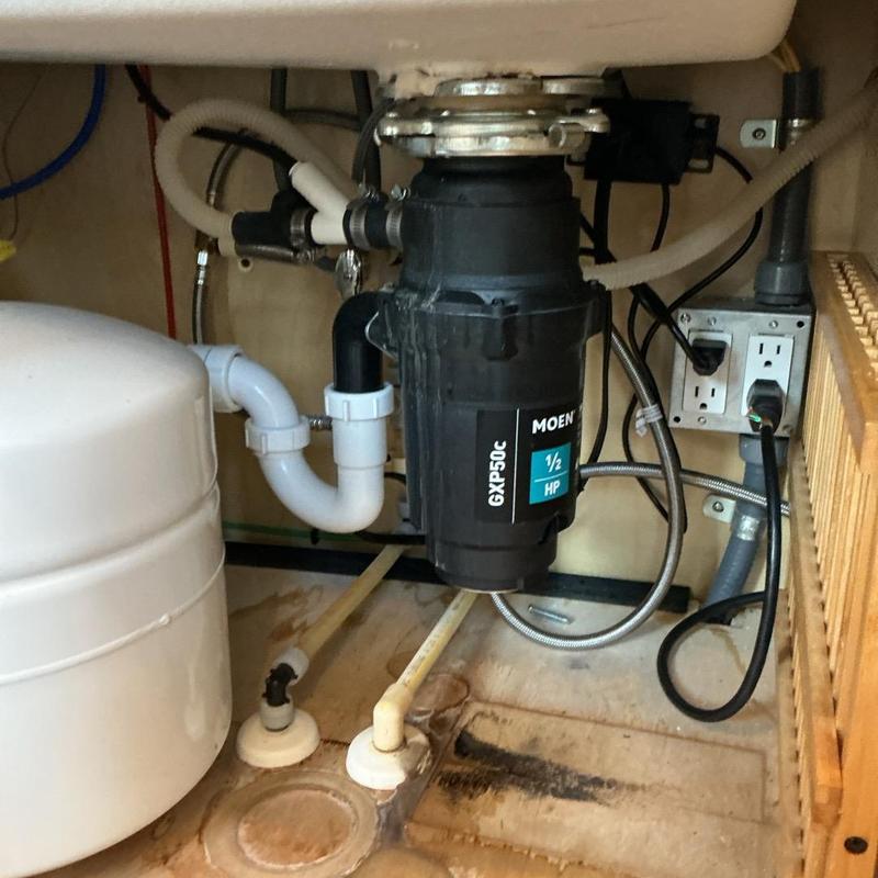 Garbage disposal unit with plumbing connections underneath sink Garbage disposal unit with plumbing connections underneath sink