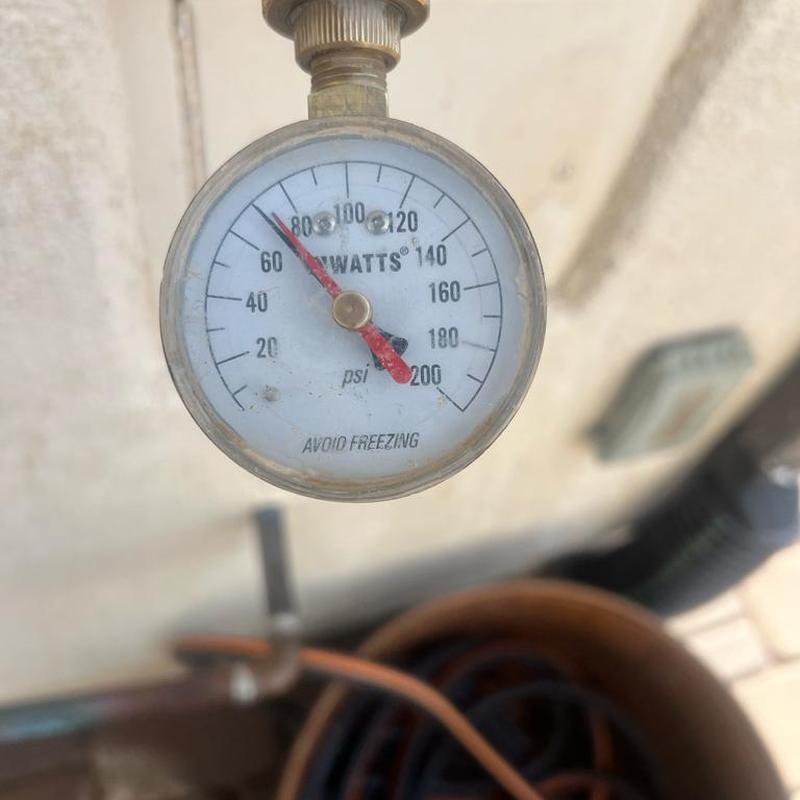 Pressure regulator valve gauge showing 68 PSI reading