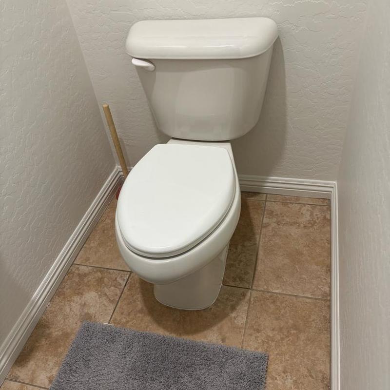 Toilet with replaced wax ring and caulked base