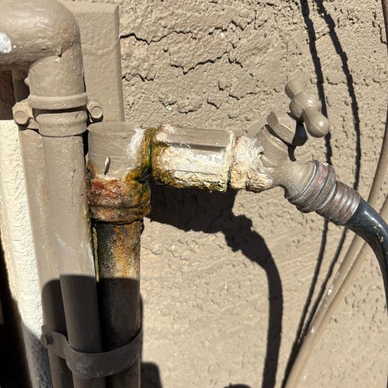 Hose bib with corrosion and rust on pipe fittings