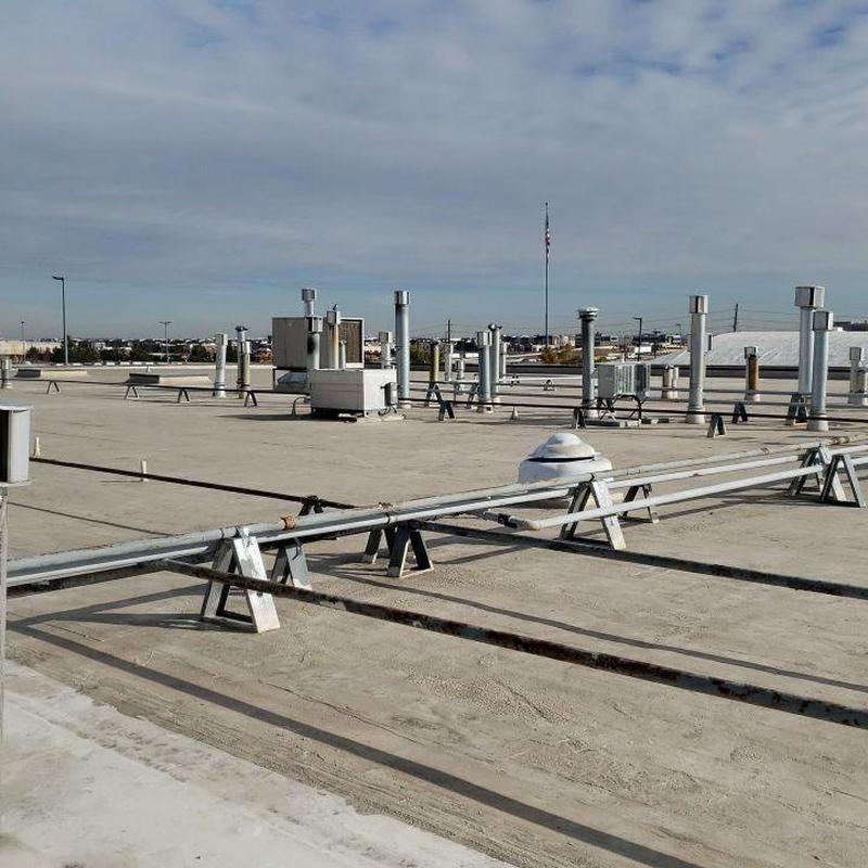 Flat commercial roof with vent pipes and equipment