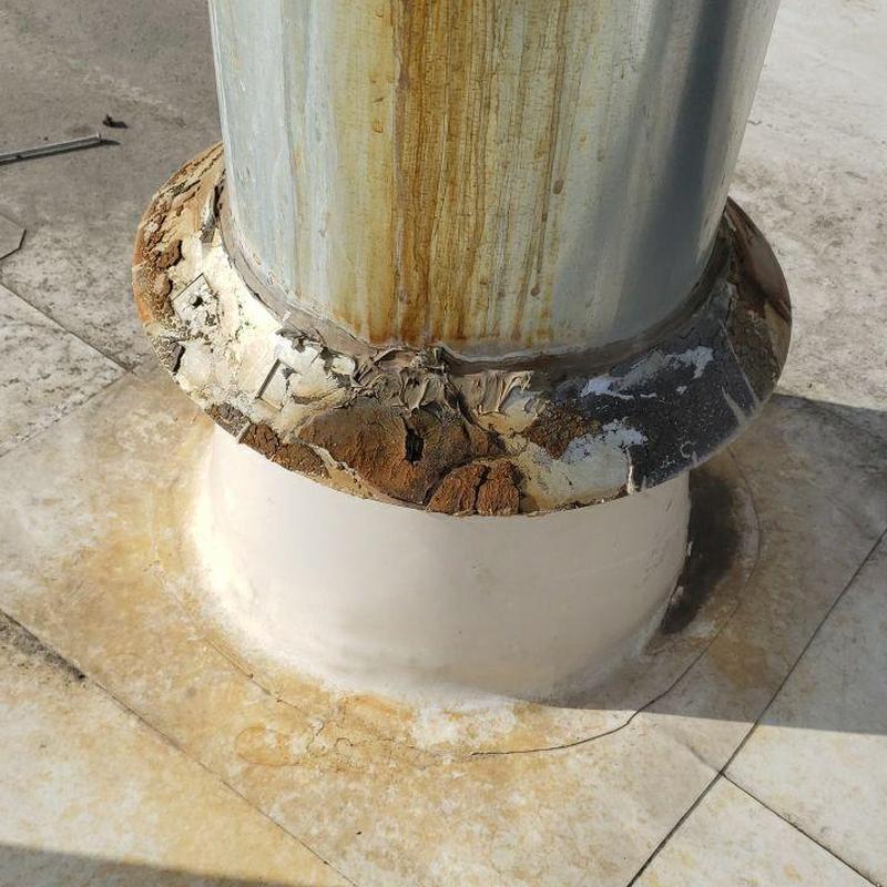 Pipe jack seal with rust and deterioration on flat roof
