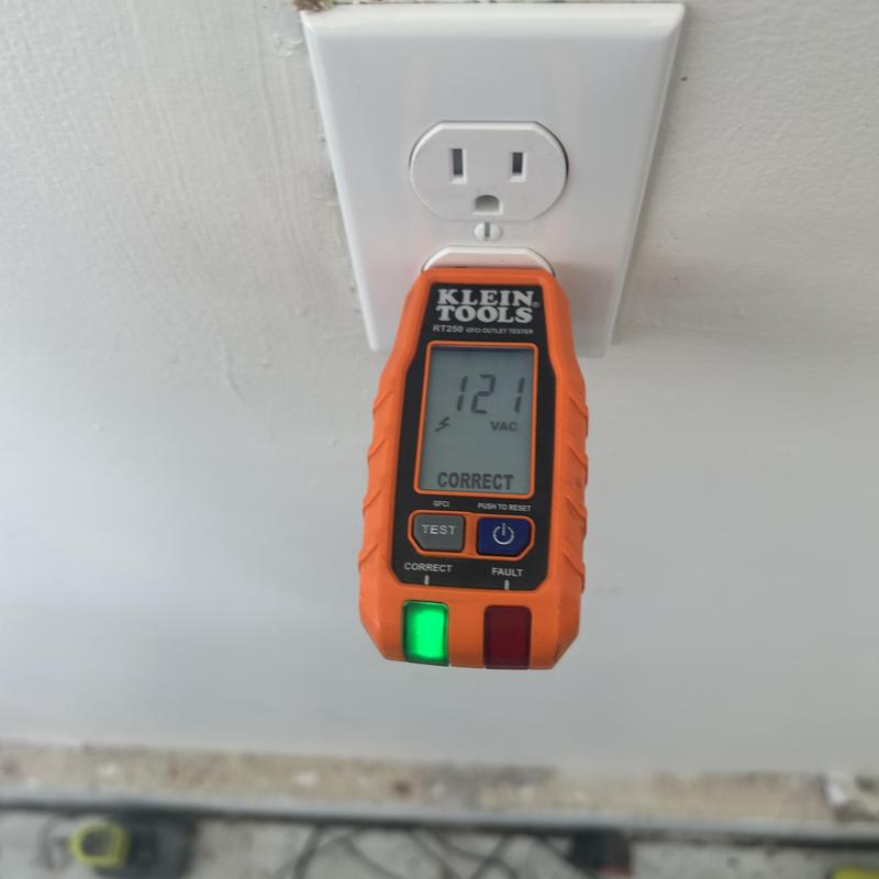 Electrical outlet with voltage tester reading correct