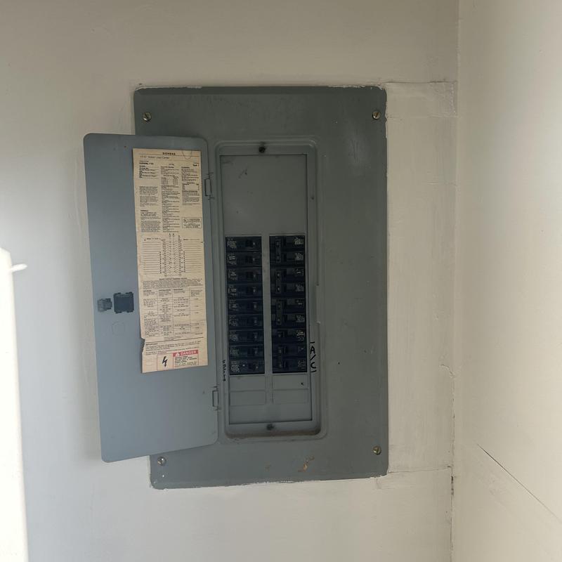 Main electrical panel with open circuit breaker door