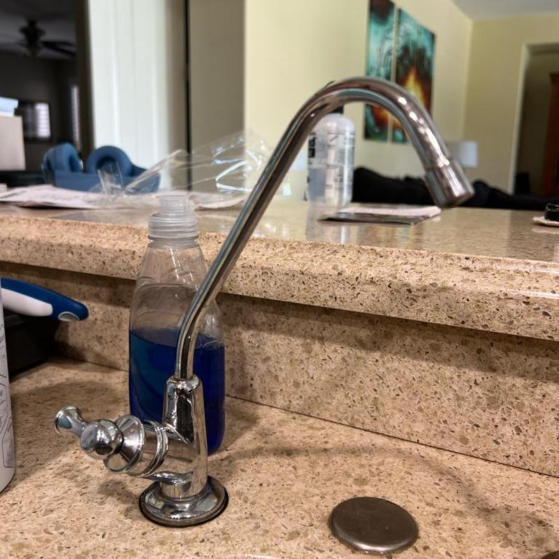 Reverse osmosis faucet installation on kitchen countertop