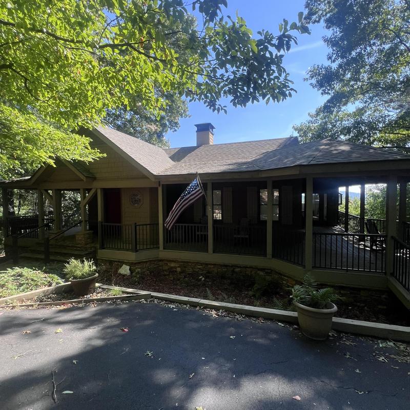 Custom chimney cap and shroud on mountain home exterior