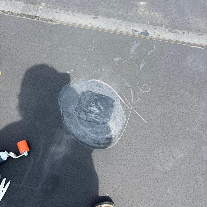 EPDM roofing membrane with patched hail damage area