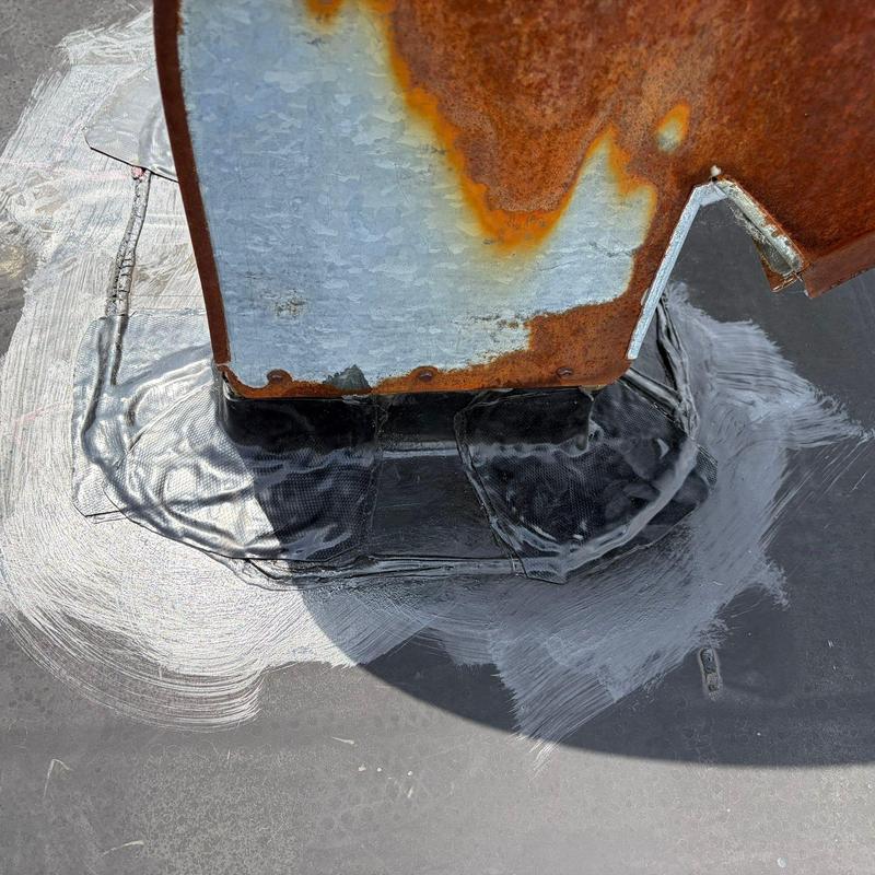 Metal roof flashing with rust and sealant repair