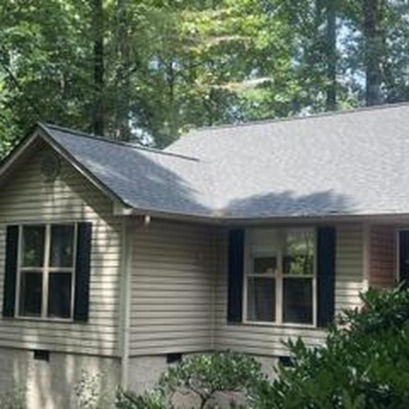 Roof replacement and gutter section replacement on house exterior