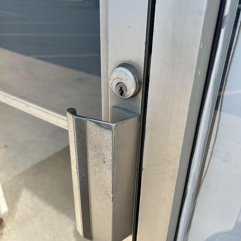 Front door lock cylinder and metal handle close-up Front door lock cylinder and metal handle close-up