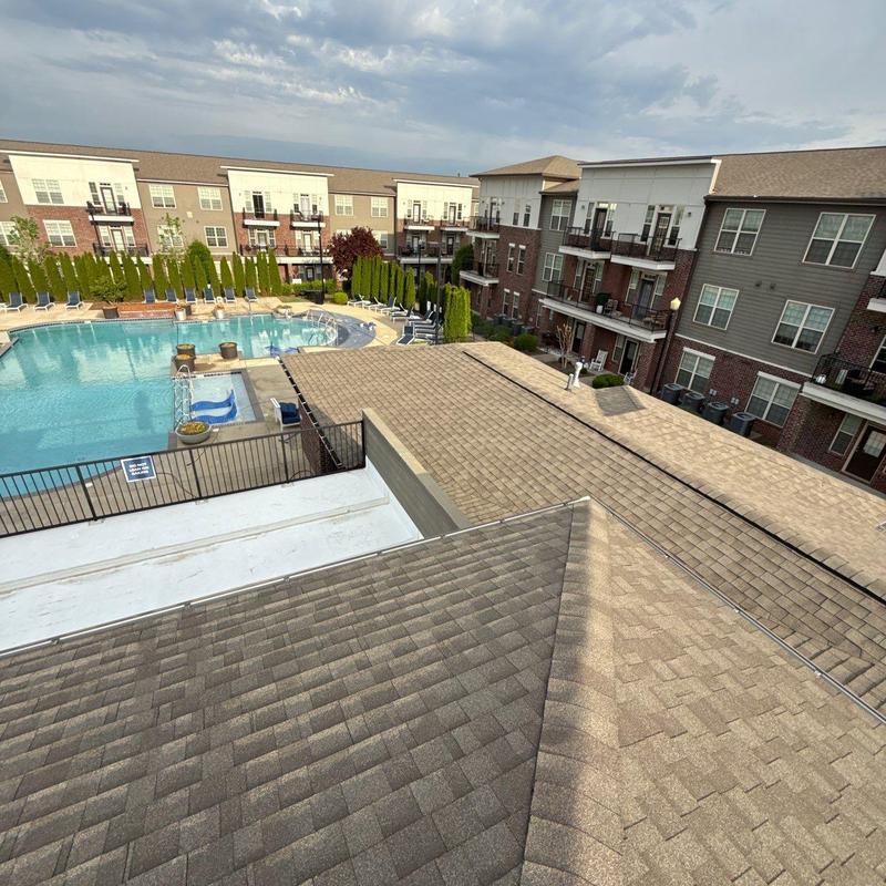 Asphalt shingle roof inspection with pool and apartments