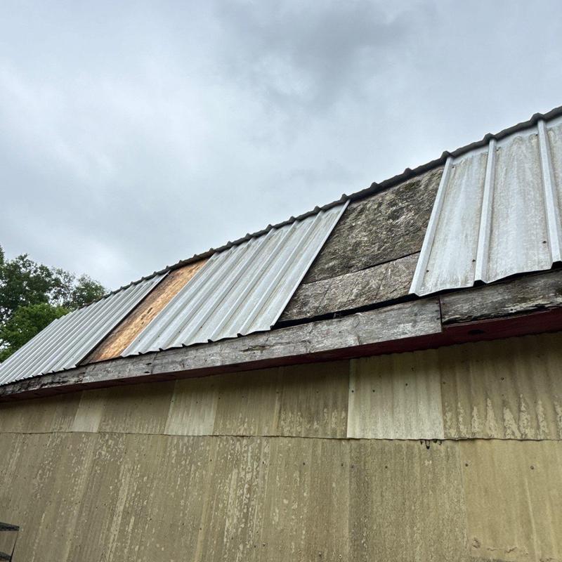 Corrugated metal roof panels with wood underlayment damage