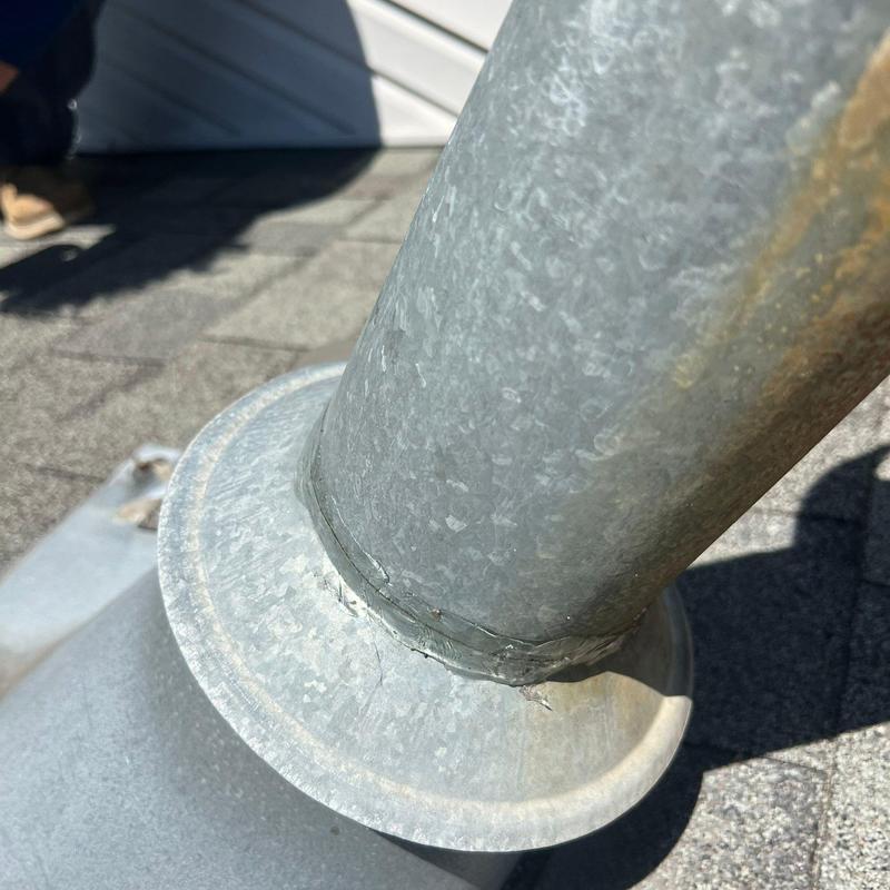 Metal roof vent pipe flashing with visible cracks