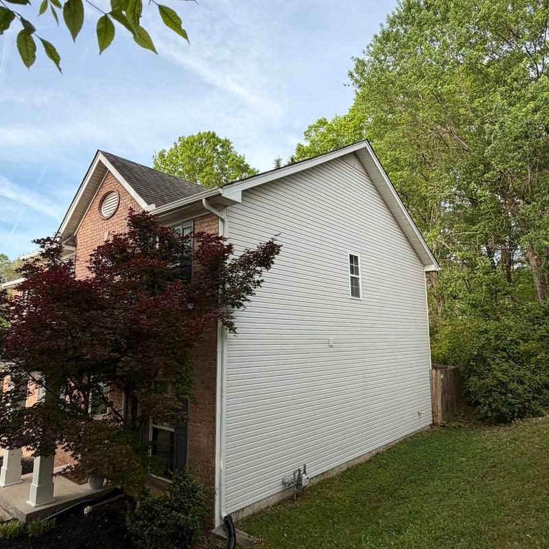 Asphalt shingle roof with gutter system and siding panels