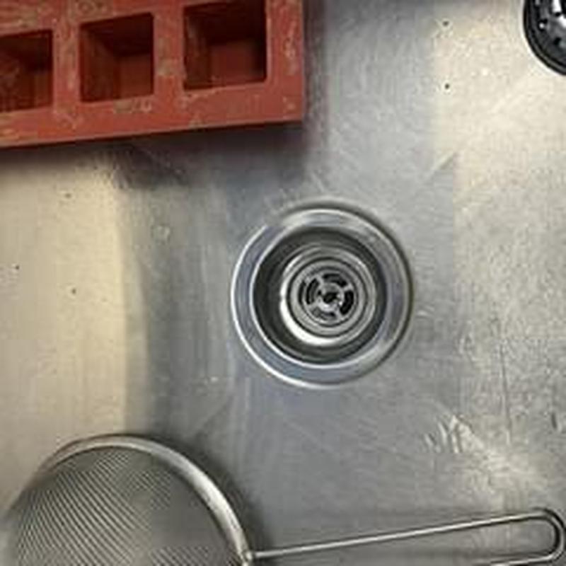 Basket strainer and sink drain in stainless steel sink