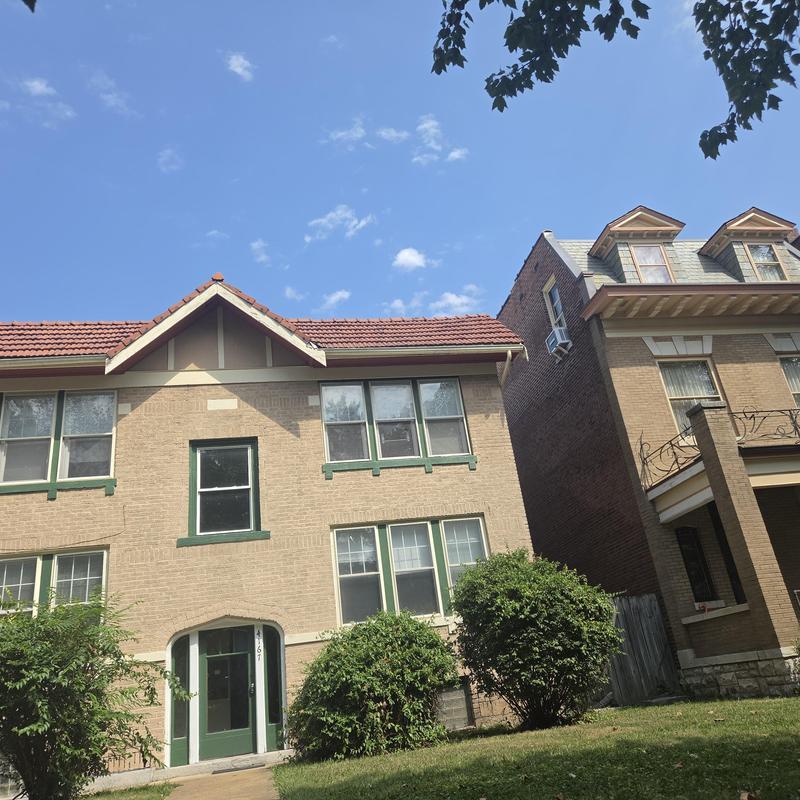 Clay tile roof and window screens on two-story home