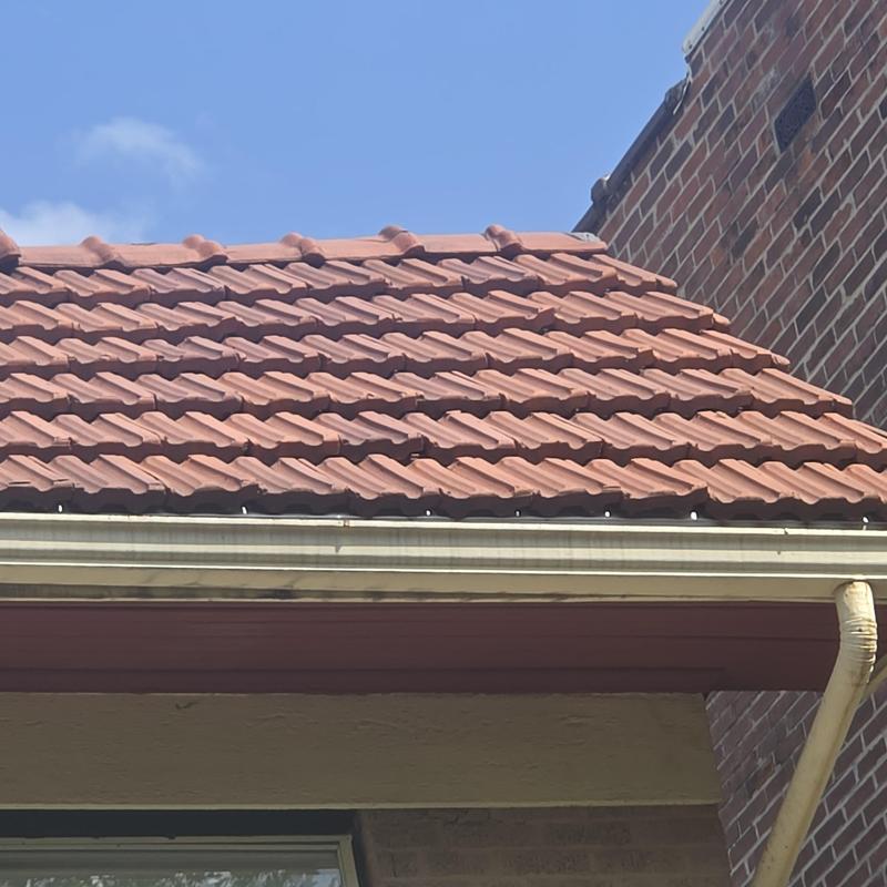 Clay tile roof with gutter and downspout system