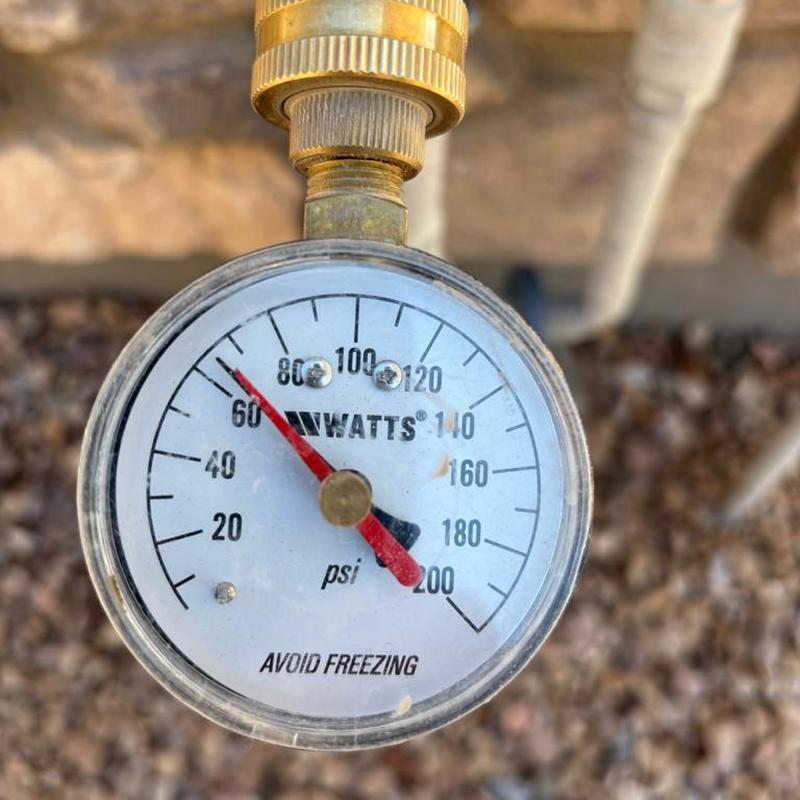 Pressure reducing valve gauge showing water pressure at 65 psi