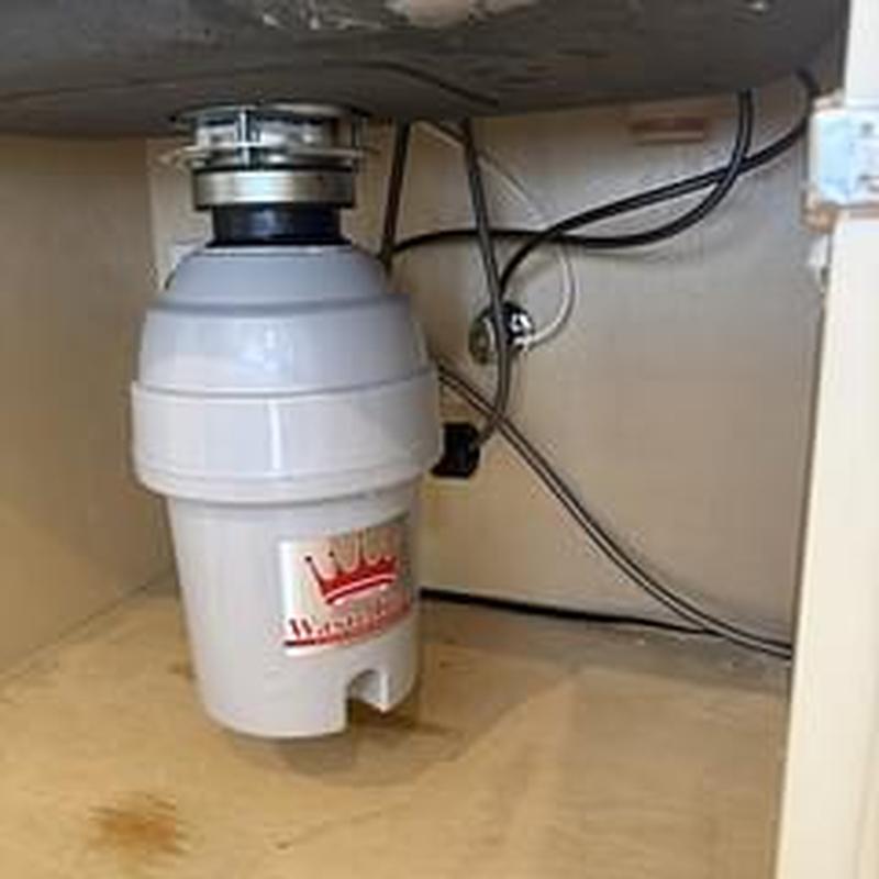 Garbage disposal installation under kitchen sink