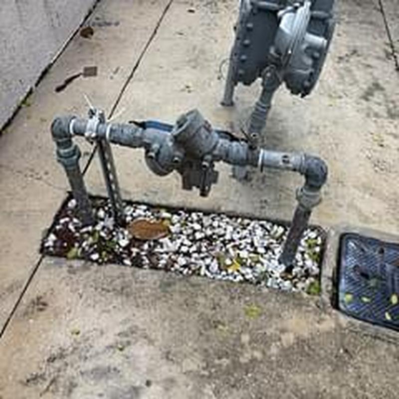Domestic backflow prevention device with piping system