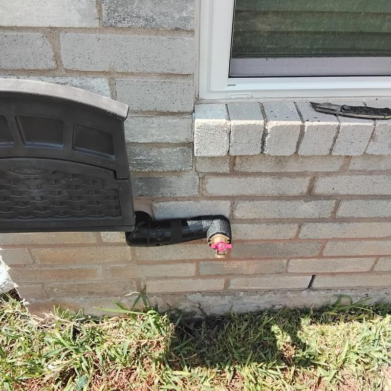 Backyard hose bib with insulated piping near window Backyard hose bib with insulated piping near window