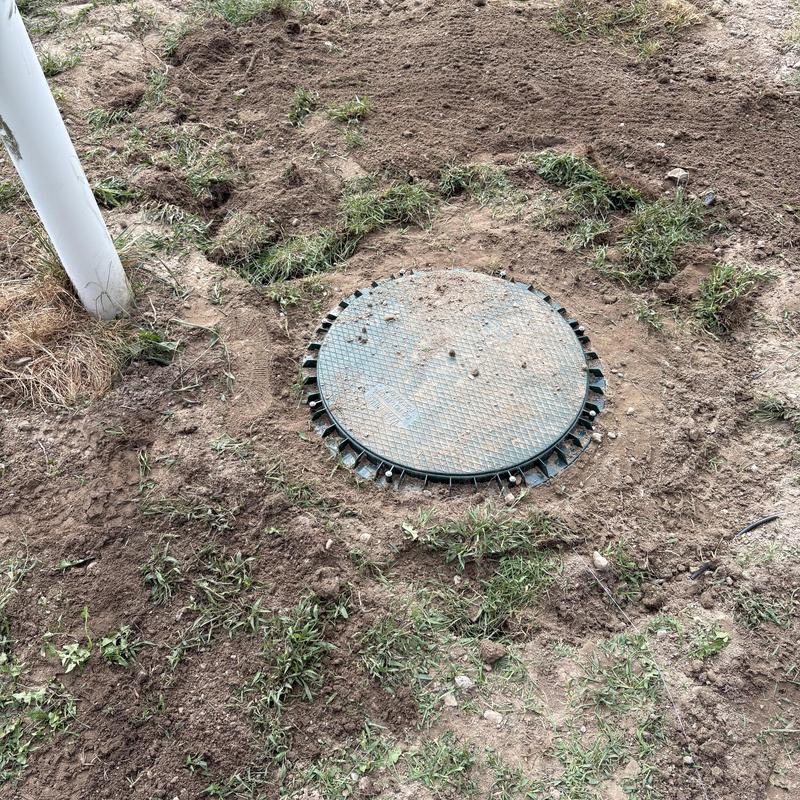 Composite sewer ejector pump tank cover installed outdoors Composite sewer ejector pump tank cover installed outdoors