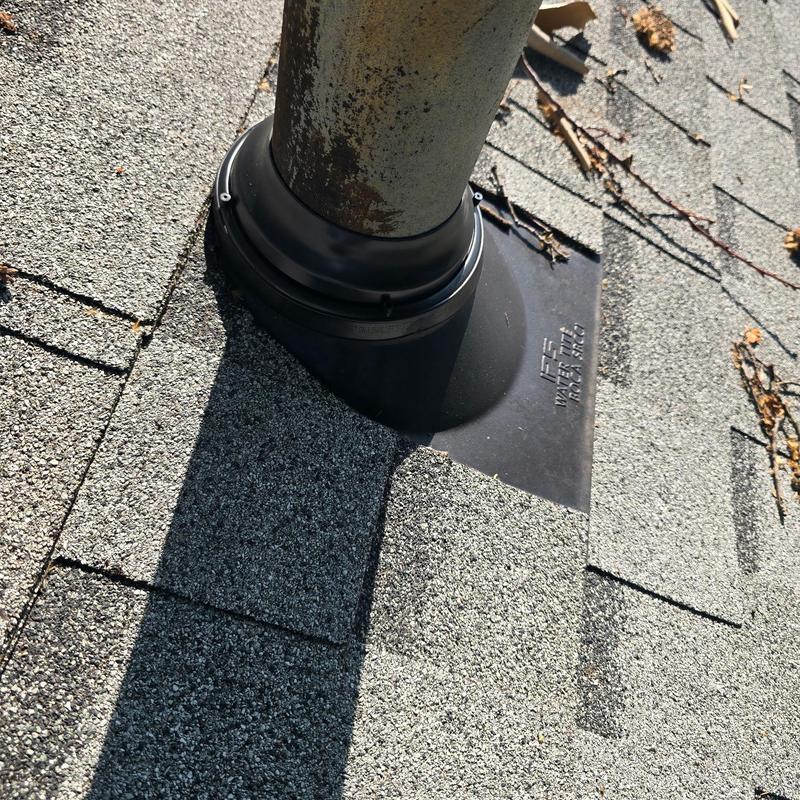 Roof vent pipe flashing with shingles on asphalt roof Roof vent pipe flashing with shingles on asphalt roof
