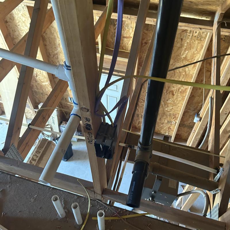 PVC plumbing pipes and electrical wiring in ceiling framing PVC plumbing pipes and electrical wiring in ceiling framing