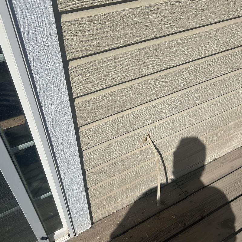 Outdoor water spigot pipe protruding from house siding Outdoor water spigot pipe protruding from house siding