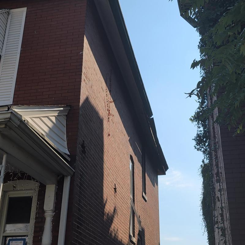 Gutter and fascia damage on brick house exterior