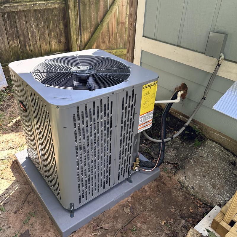 Air conditioner outdoor unit new installation in yard Air conditioner outdoor unit new installation in yard