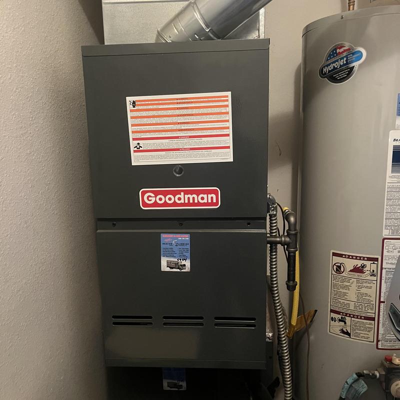 Goodman furnace unit with ventilation and water heater nearby Goodman furnace unit with ventilation and water heater nearby