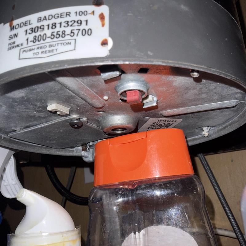 Badger 100 garbage disposal underside close-up with reset button Badger 100 garbage disposal underside close-up with reset button
