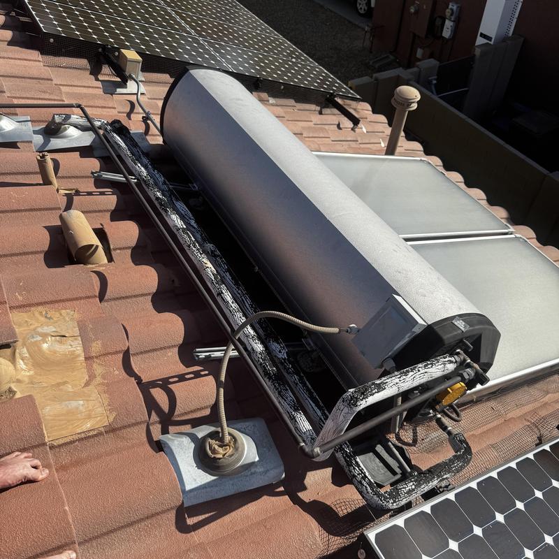 Solar water-heating system on tiled roof with panel Solar water-heating system on tiled roof with panel