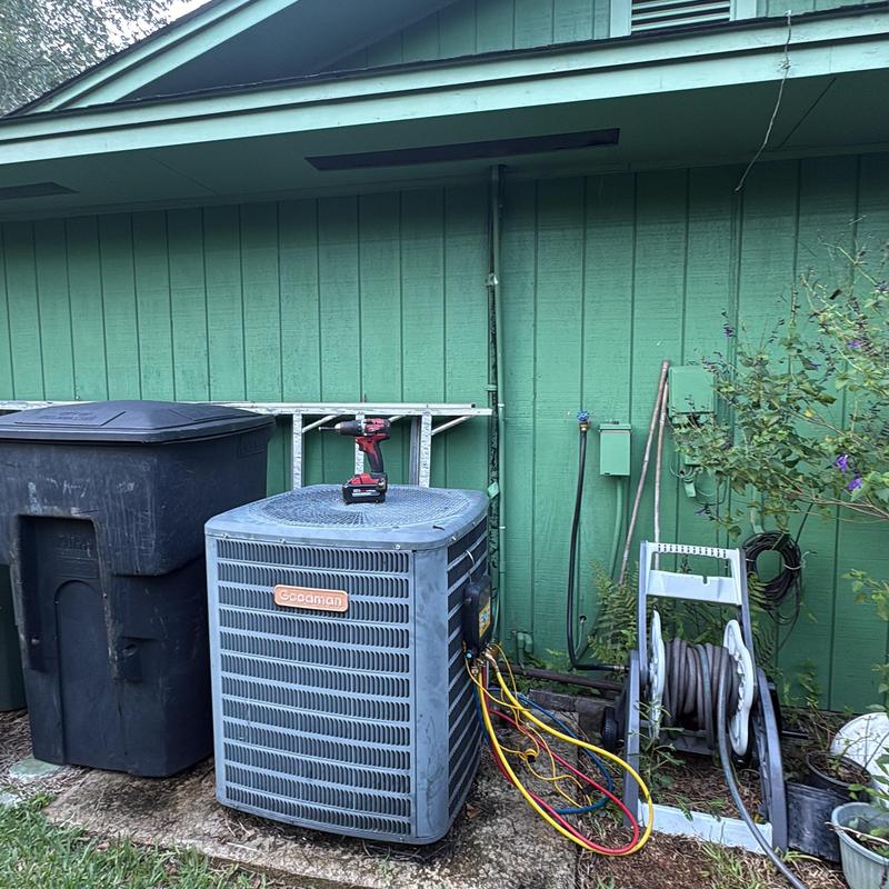 Goodman air conditioner with diagnostic gauges and tool on top Goodman air conditioner with diagnostic gauges and tool on top