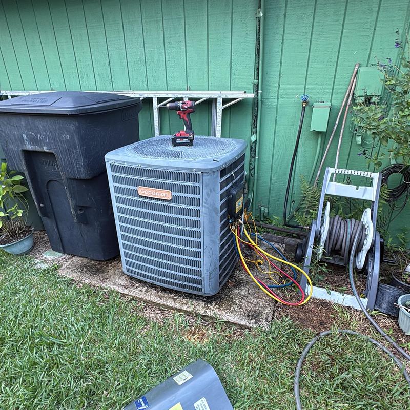 Goodman air conditioner unit with diagnostic gauges outdoors Goodman air conditioner unit with diagnostic gauges outdoors